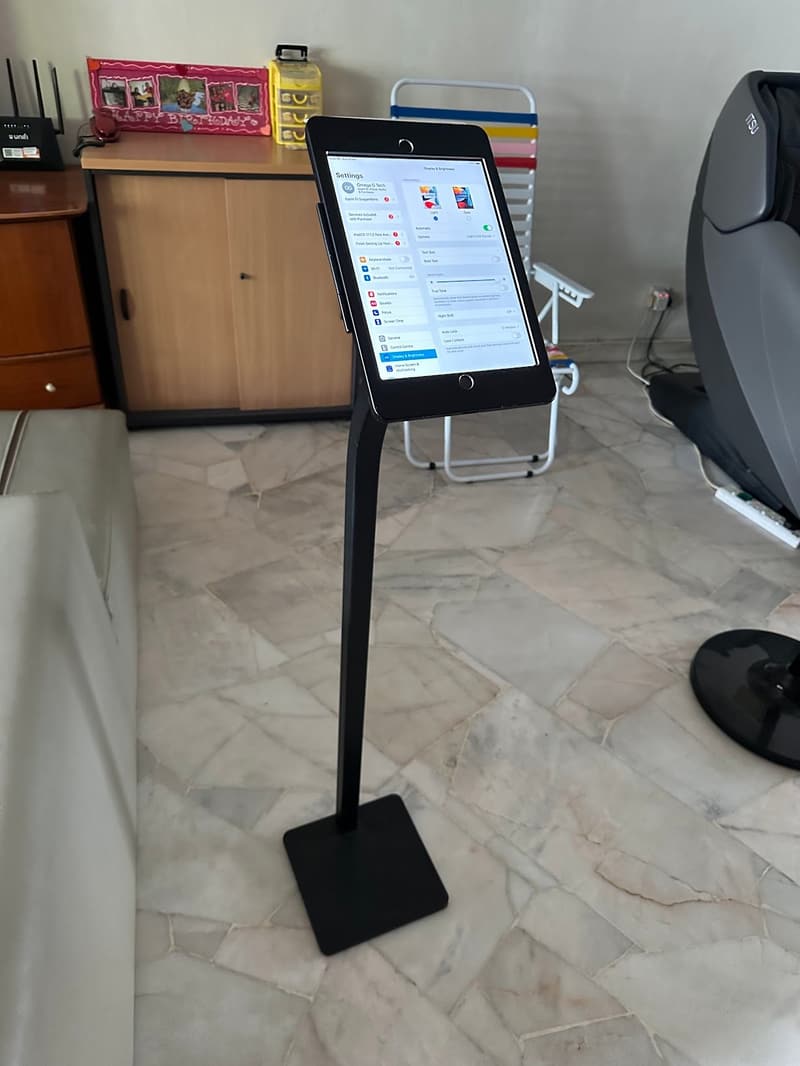 A single iPad floor stand set up indoors beside a display counter
