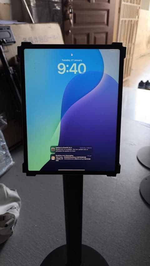 iPad in a metal anti-theft enclosure mounted on a floor-standing pole