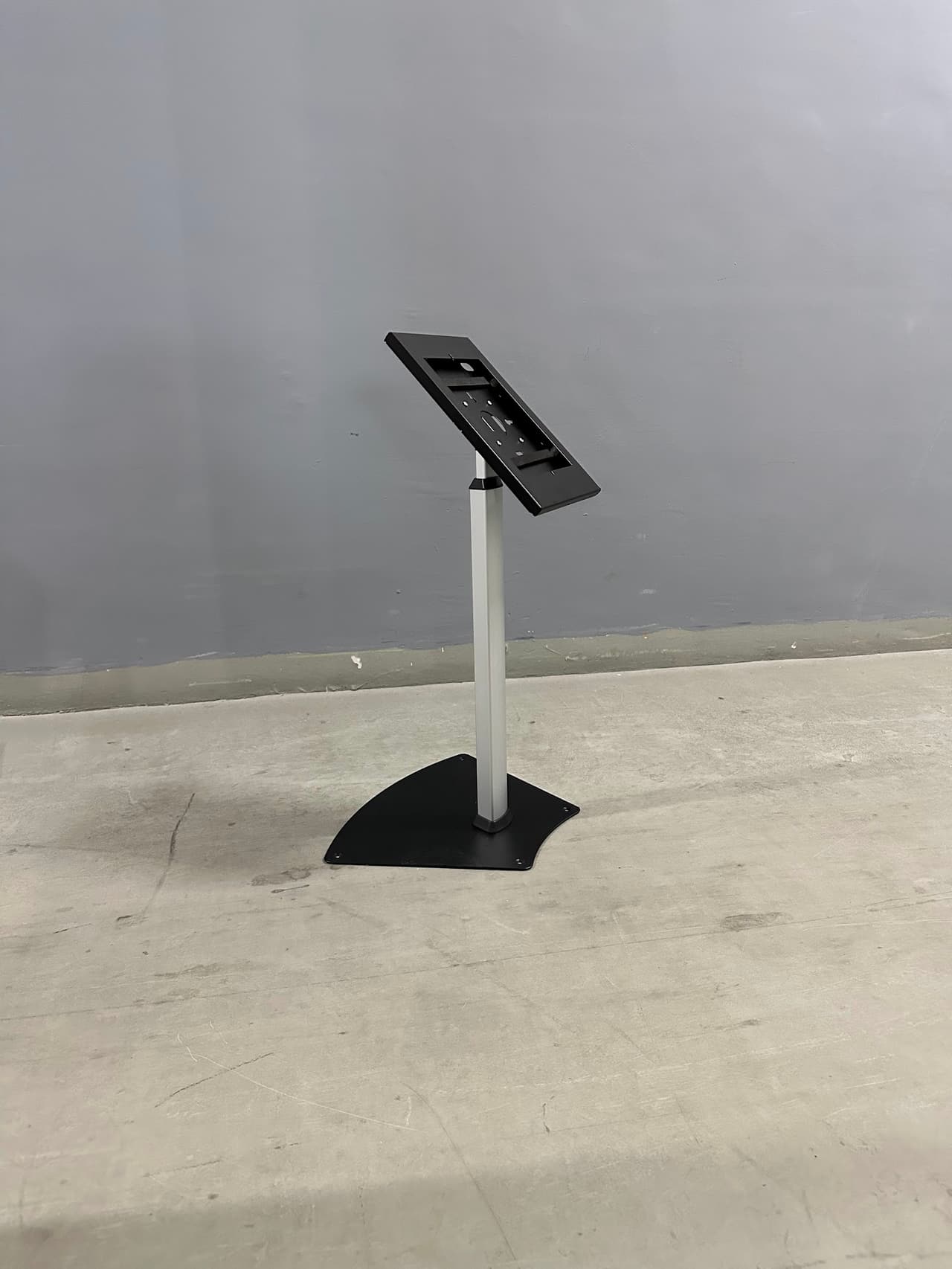 Black telescopic stand holding an iPad in landscape orientation