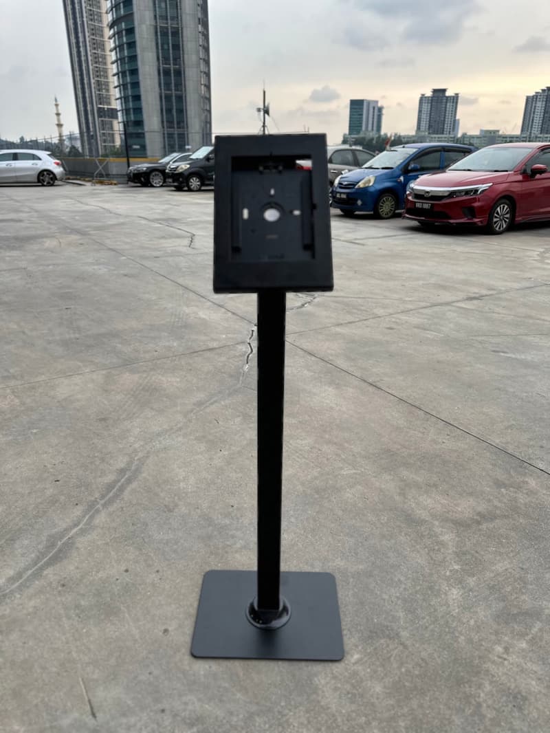 Empty iPad floor stand cradle photographed from the front outdoors