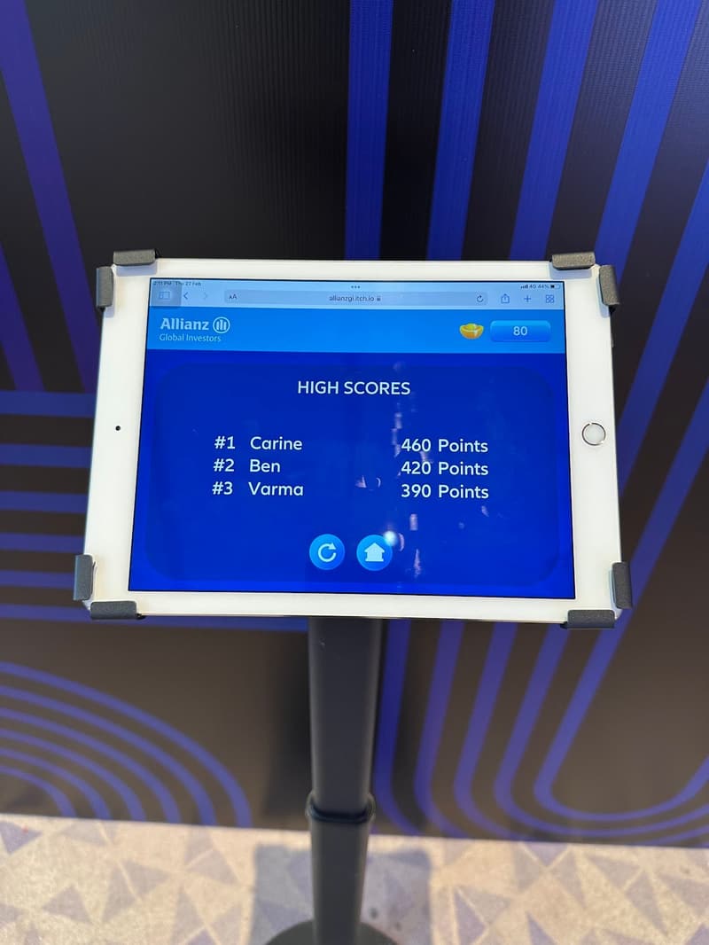 An iPad on a floor stand displaying a live scoreboard at a roadshow booth