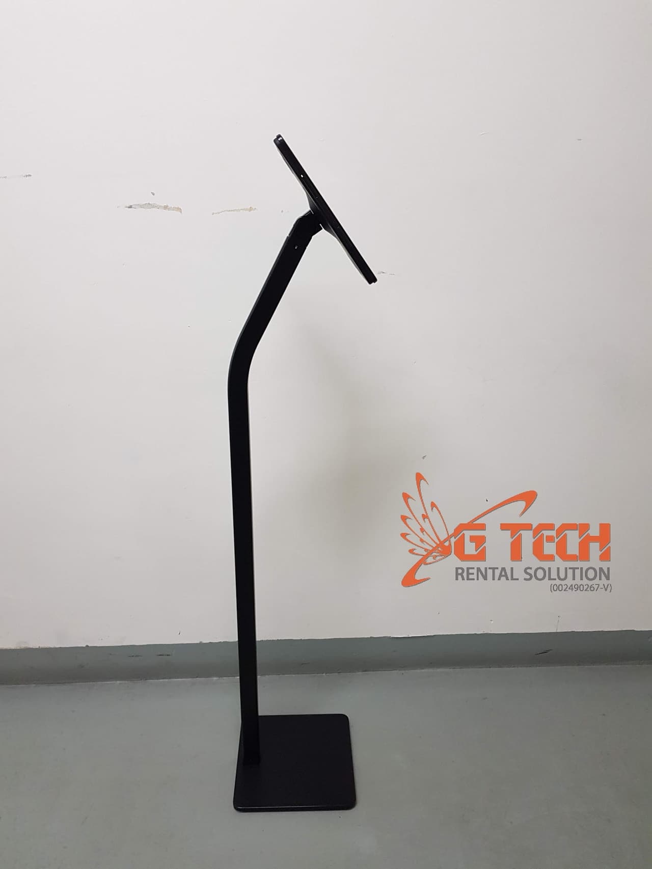 Black iPad floor stand seen from the side with an empty cradle