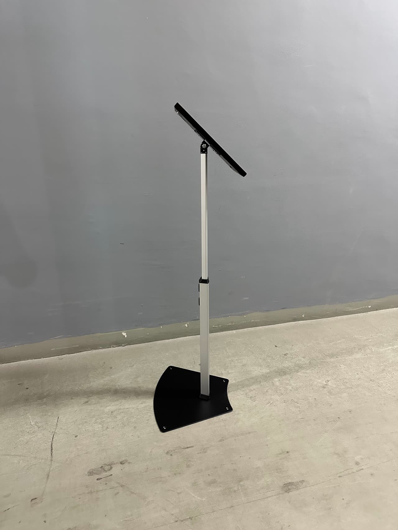 White telescopic iPad stand extended and tilted to landscape