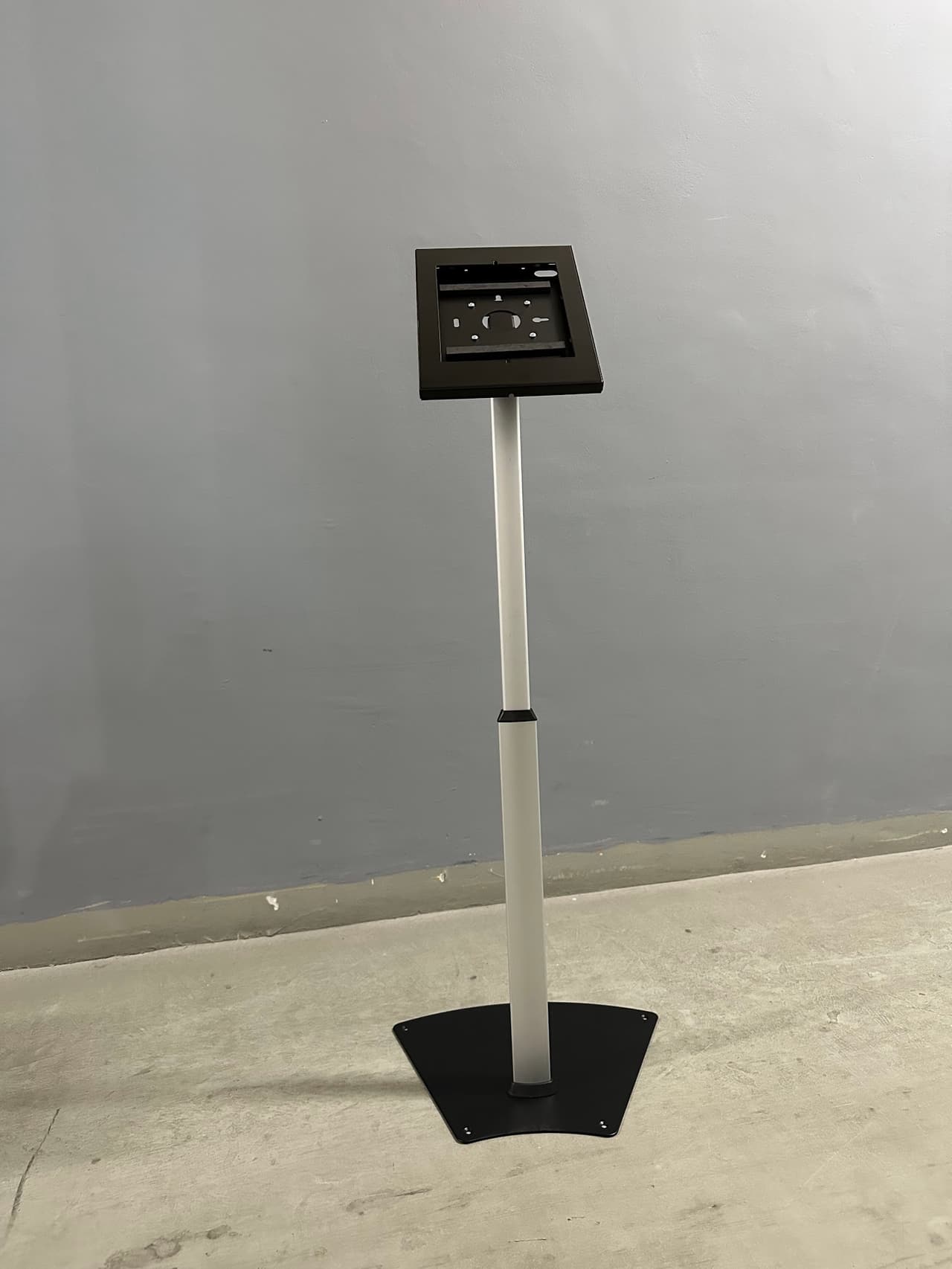 White telescopic iPad floor stand with a fan-shaped base