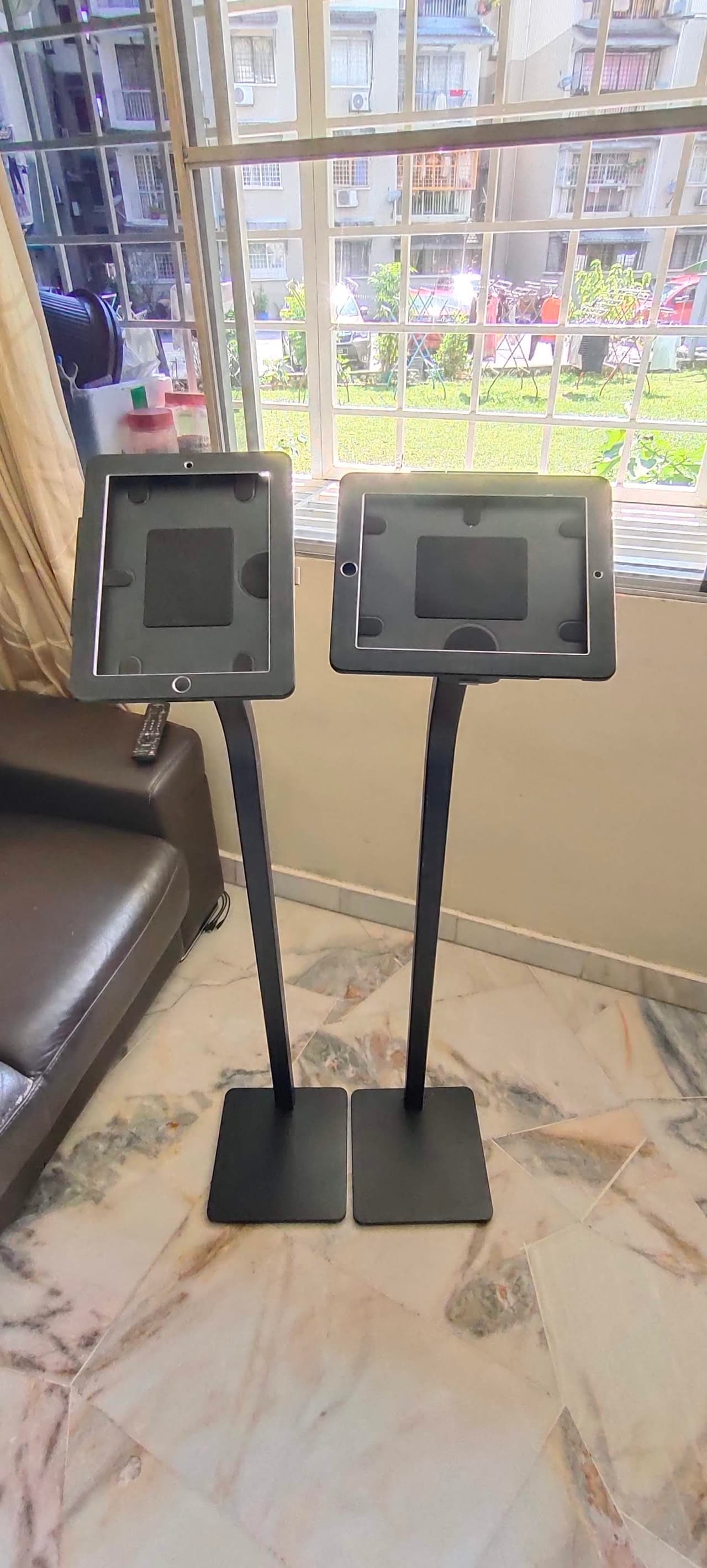 Two iPad floor stands side by side in a function room
