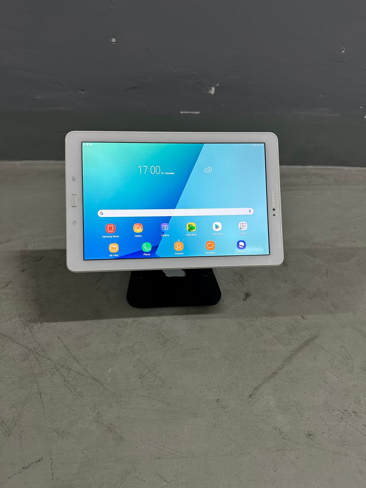 Tablet on a weighted desk stand in landscape orientation