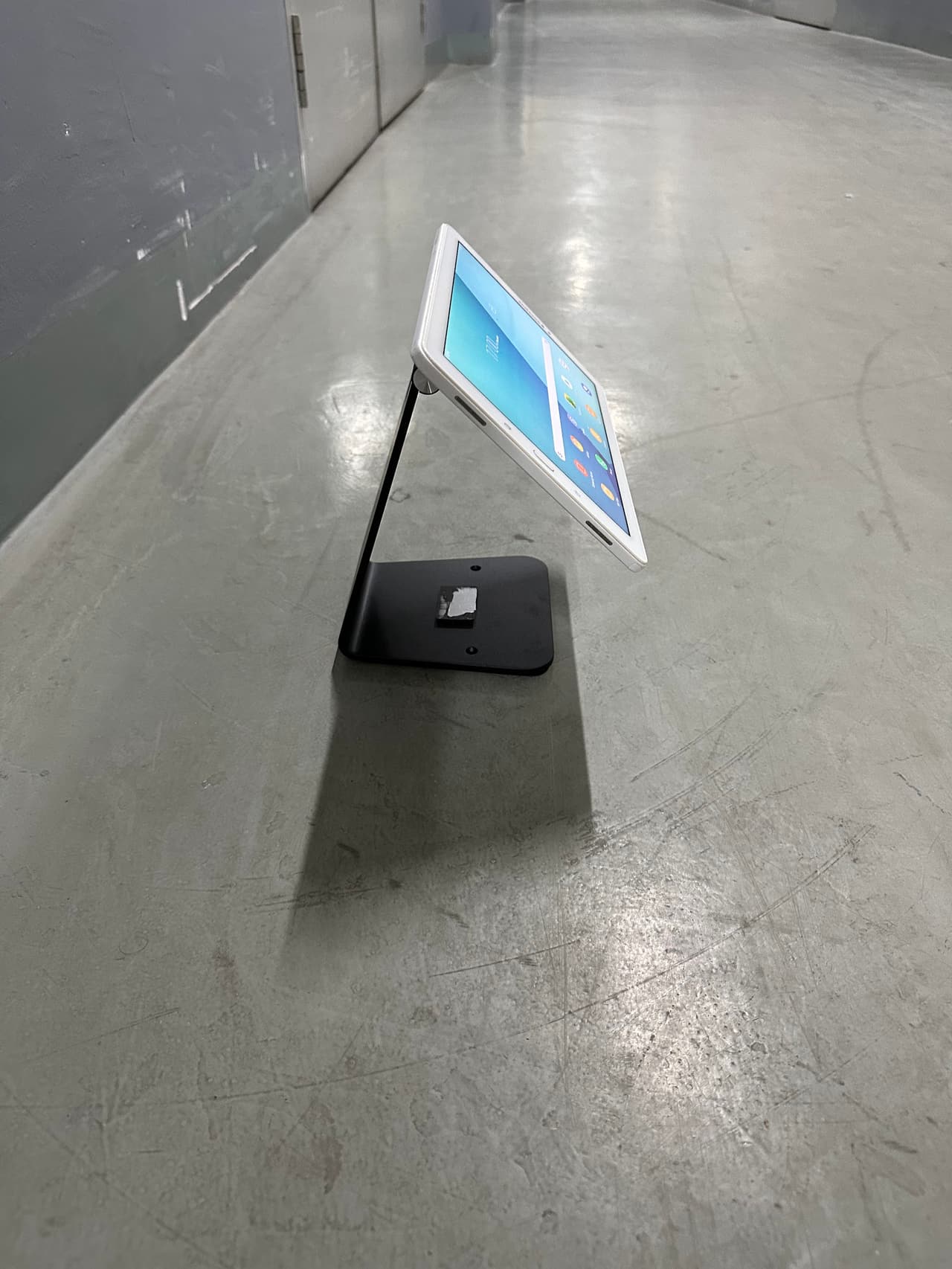 Tablet on a low table stand tilted for signing